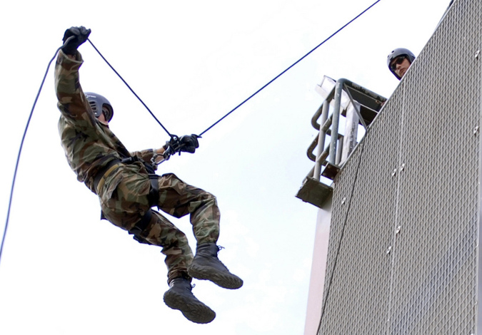 Man repelling from a tower